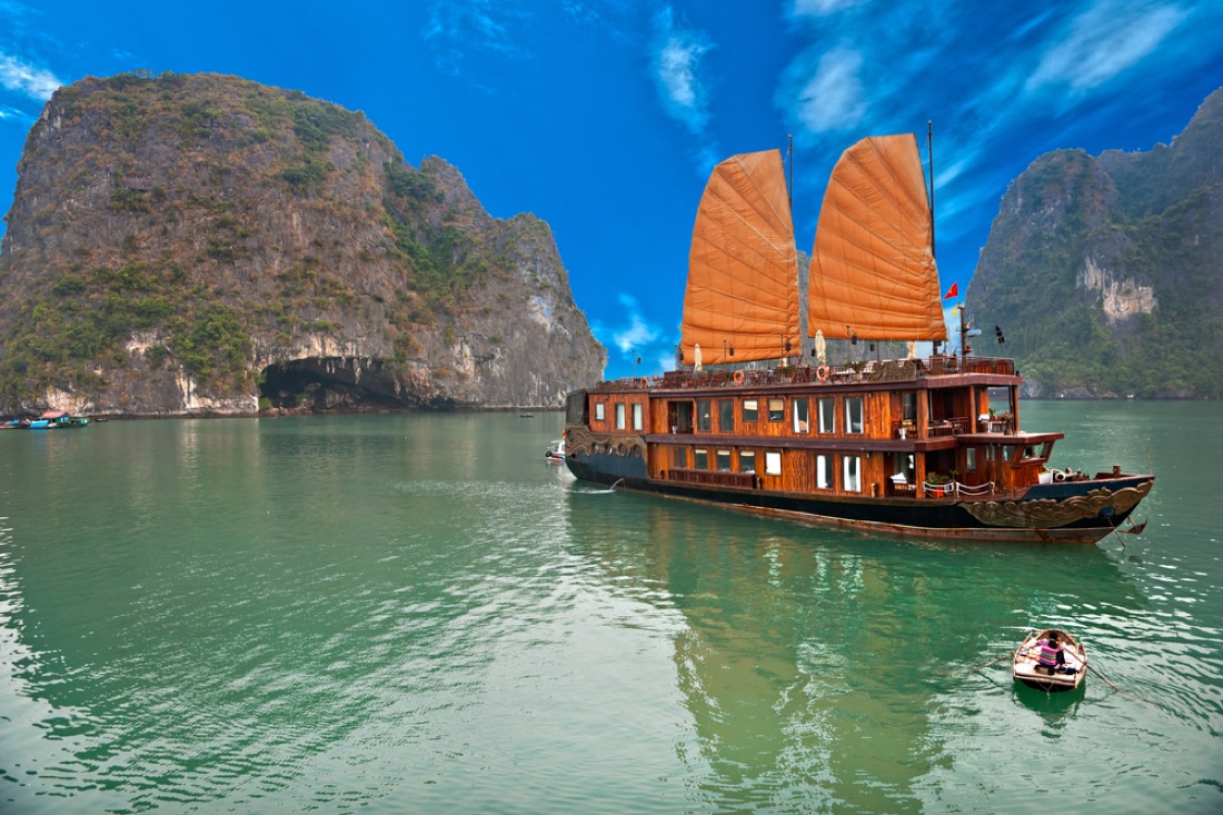 Blue skies, Halong Bay with traditional boat