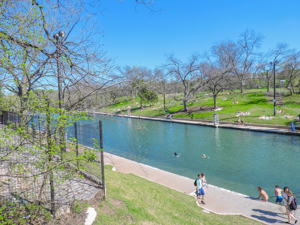 Barton Springs Pool in Austin 1000 foot watering hole with grassy embankment 