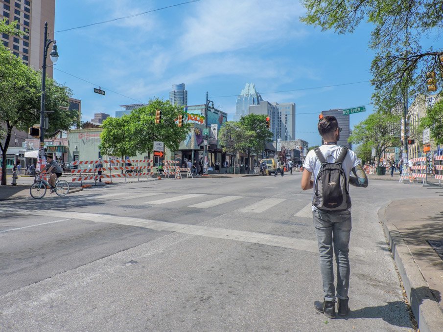 Man standing with back to camera on 6th Street in Austin Texas