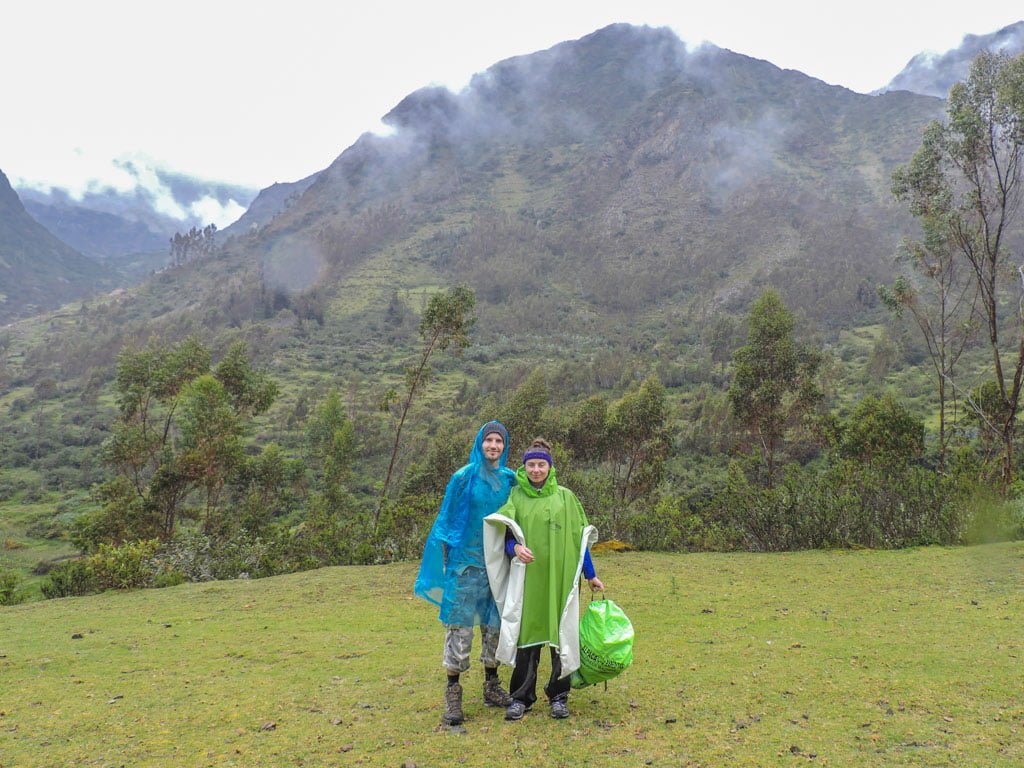 Couple ponchos Peru hike
