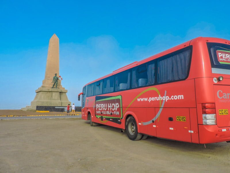 Peru Hop bus in front of monument in Lima Peru