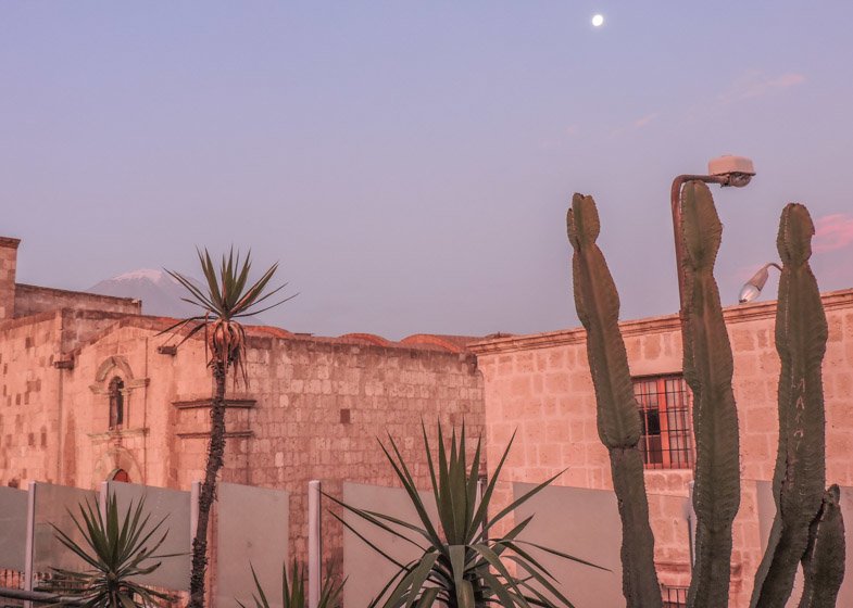 Lilac sunset in Arequipa, Peru with buildings and moon