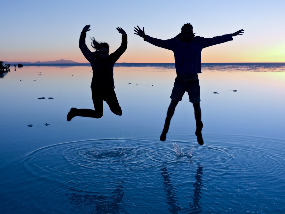 Couple Jump Shadows Sunset Bolivia Salt Flat Uyuni