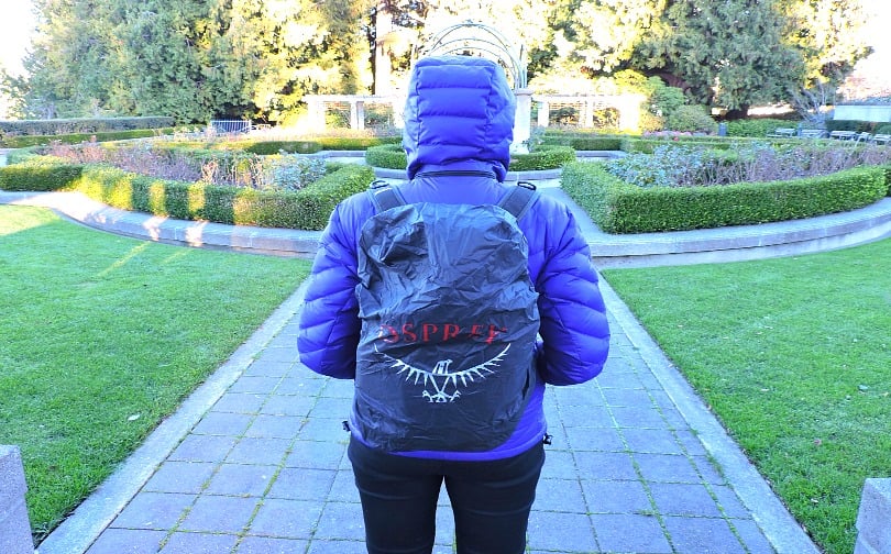 Woman wearing a bag with an Osprey bag cover 