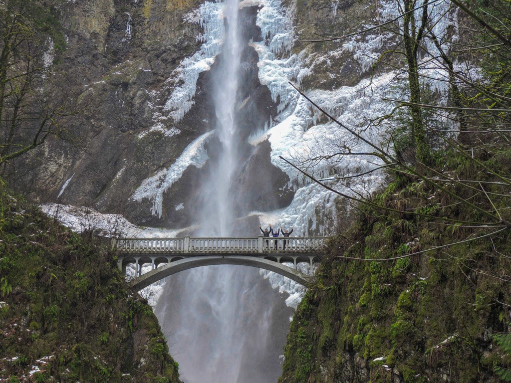 Multnomah Falls frozen with snow on stones