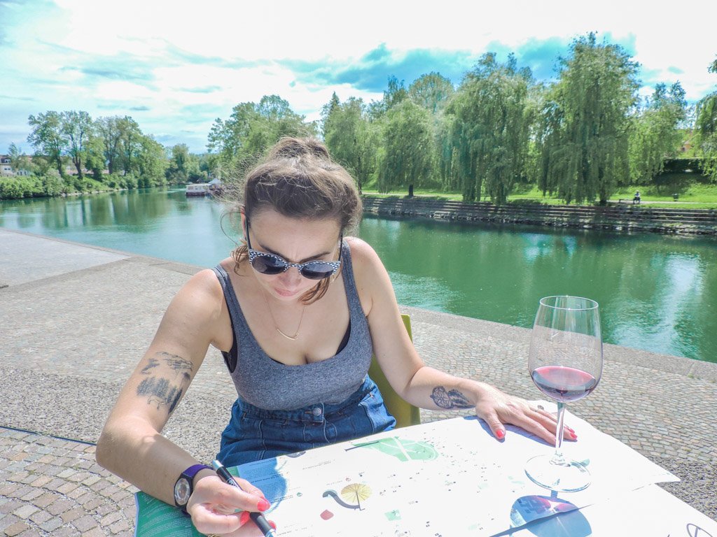 Girl looking at a map with river in background