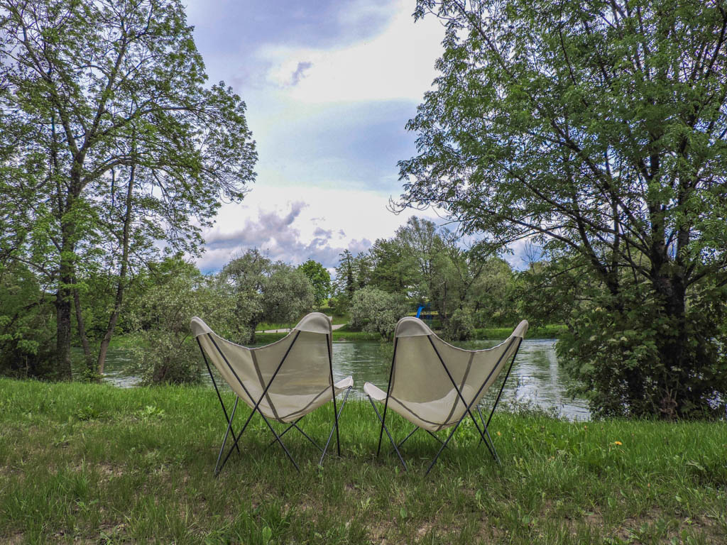Two chairs by the river at Big Berry Glampsite in  Slovenia