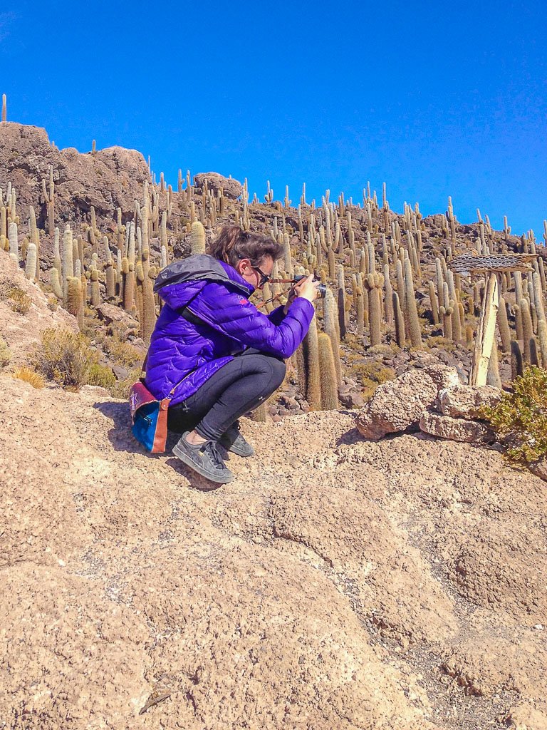 Woman taking photo on hunches using Nikon Coolpix p500 camera in Uyuni Salt Flats Bolivia