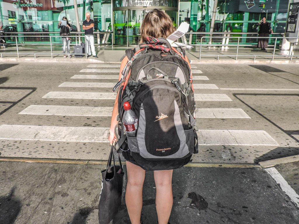 Woman wearing a large Vango Rucksack at an airport