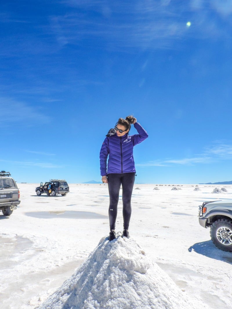Woman standing on top of Bolivia Salt Flats in Uyuni 