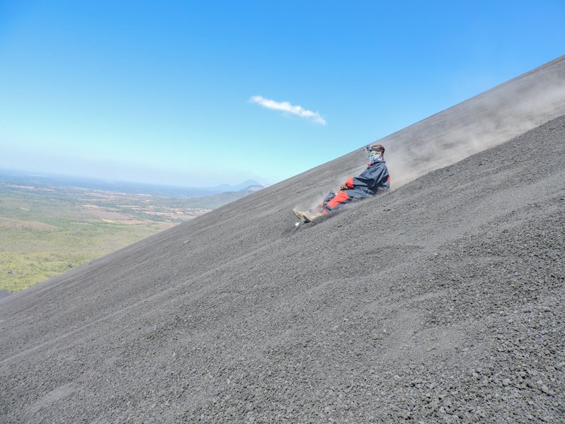 Man volcano boards down gravel hill in Leon Nicaragua 