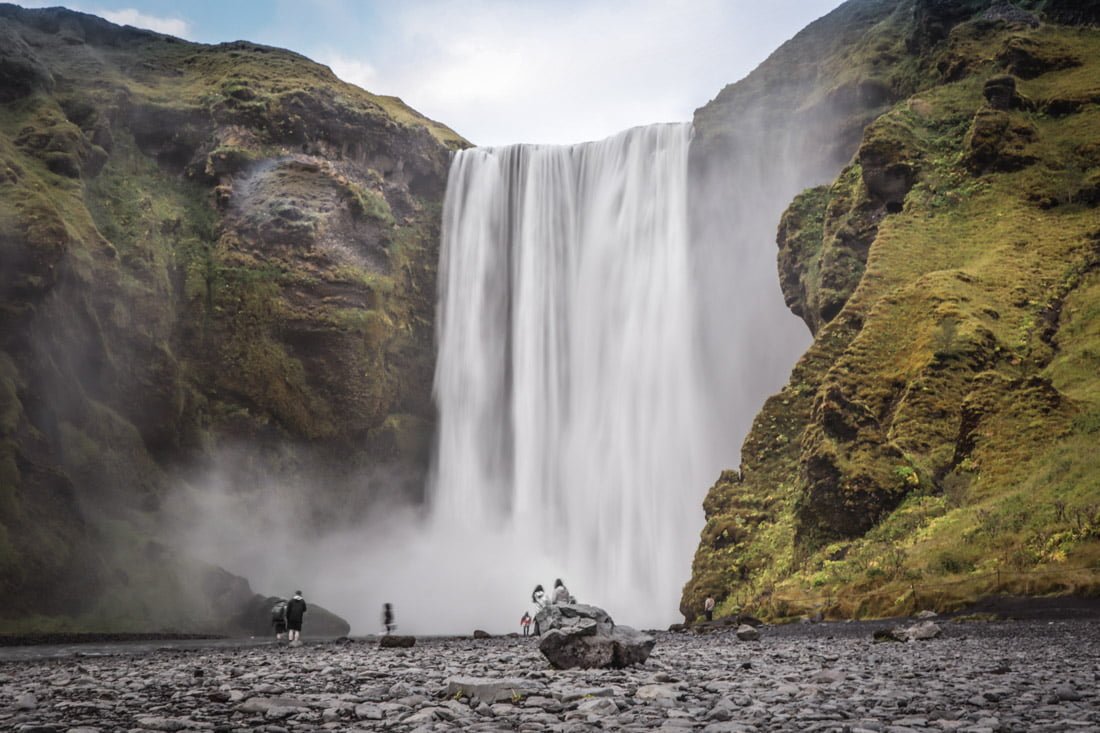 Skogafoss Waterfall flowing with rocky landscape in Iceland