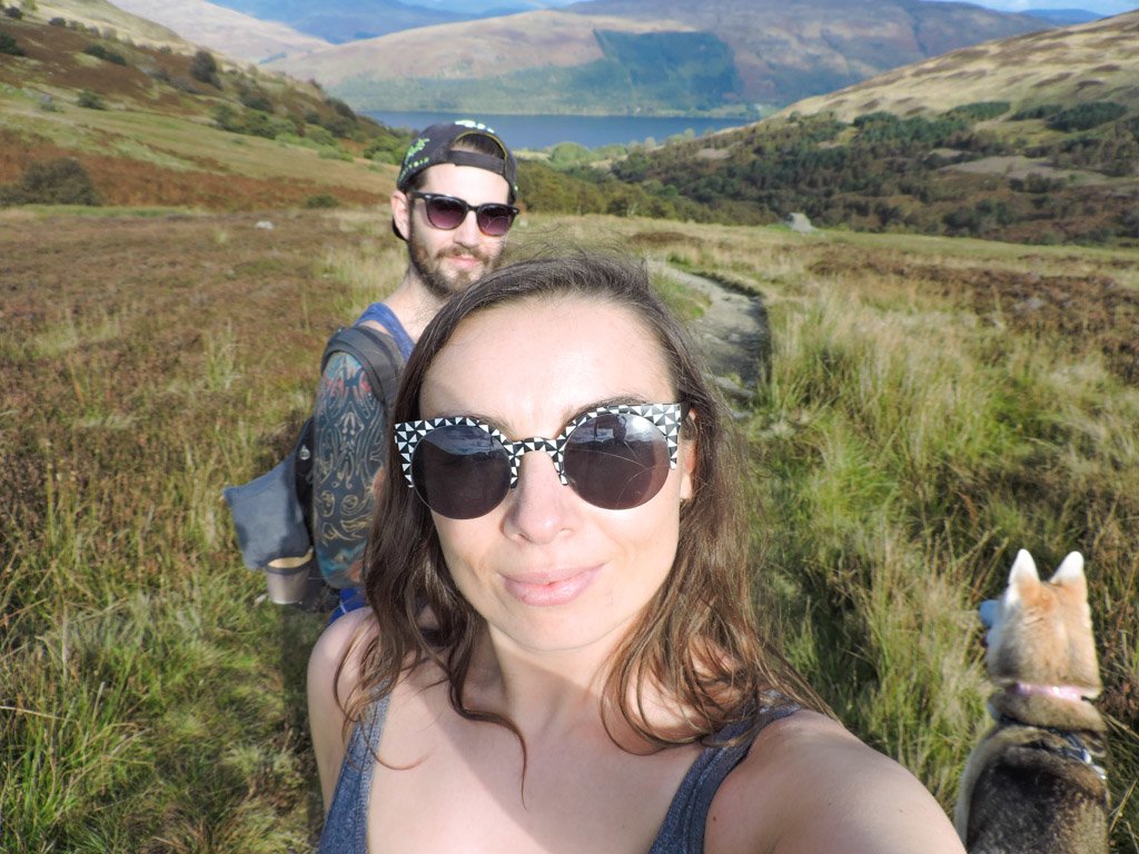 Couple and dog hiking Ben Vorlich in Scotland