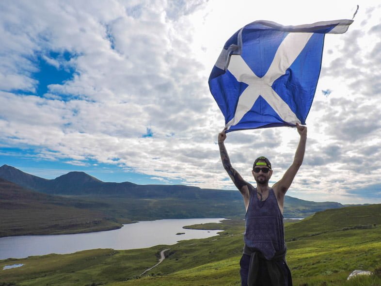 Man holiday Scotland flag at Stac Pollaidh Ullapool North Coast 500 