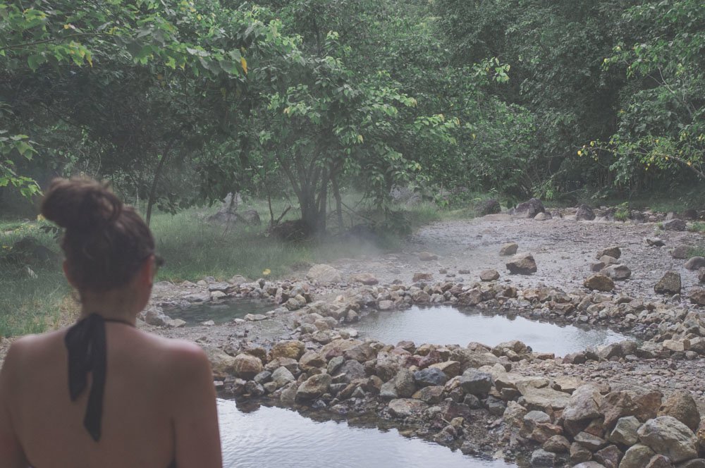 Woman standing facing hot springs in Pai Thailand