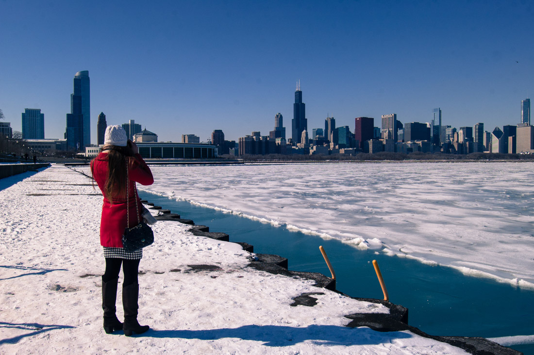 Chicago panoramic view in the winter. Woman in red coat.