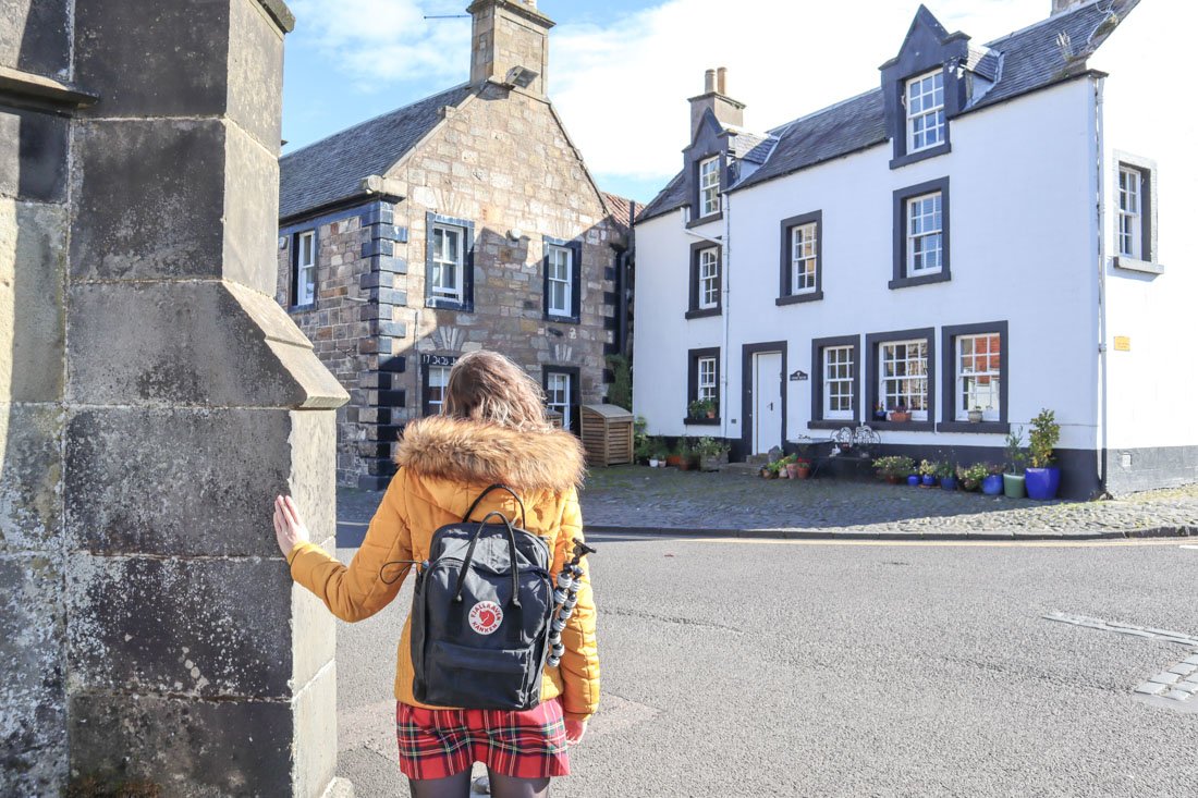 Woman posing like Jamie from Outlander at Mrs Baird B&B in the show's Inverness, Falkland in Fife