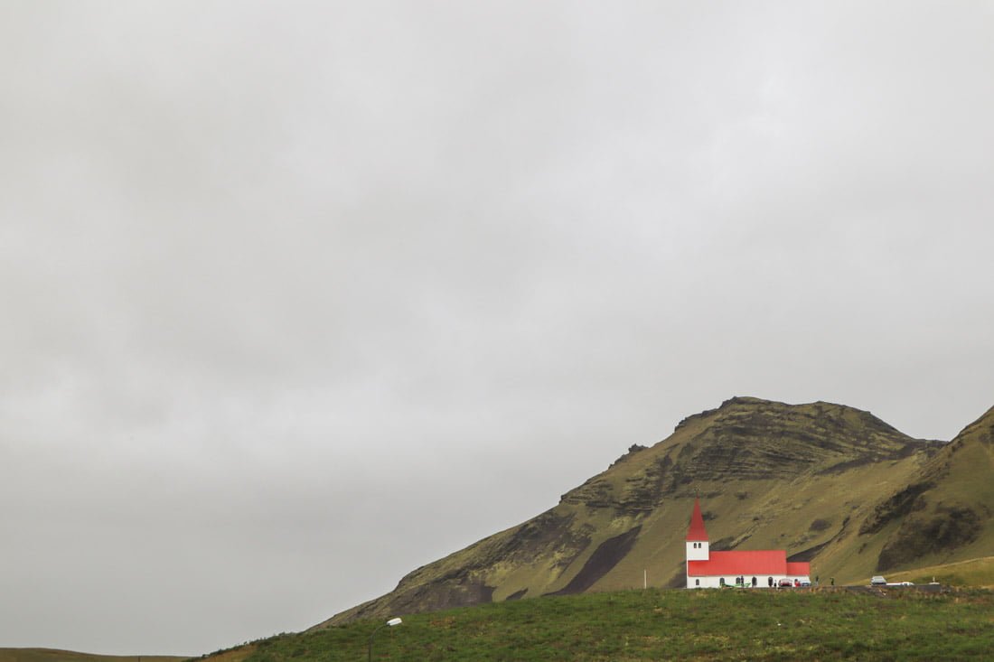 Vik, church red roof, green hills, Iceland