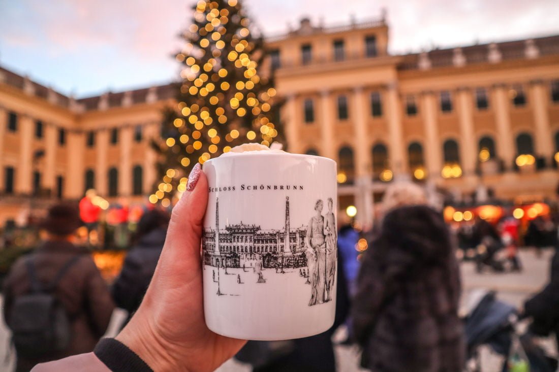 Hand holding mulled wine cup in Vienna Austria 