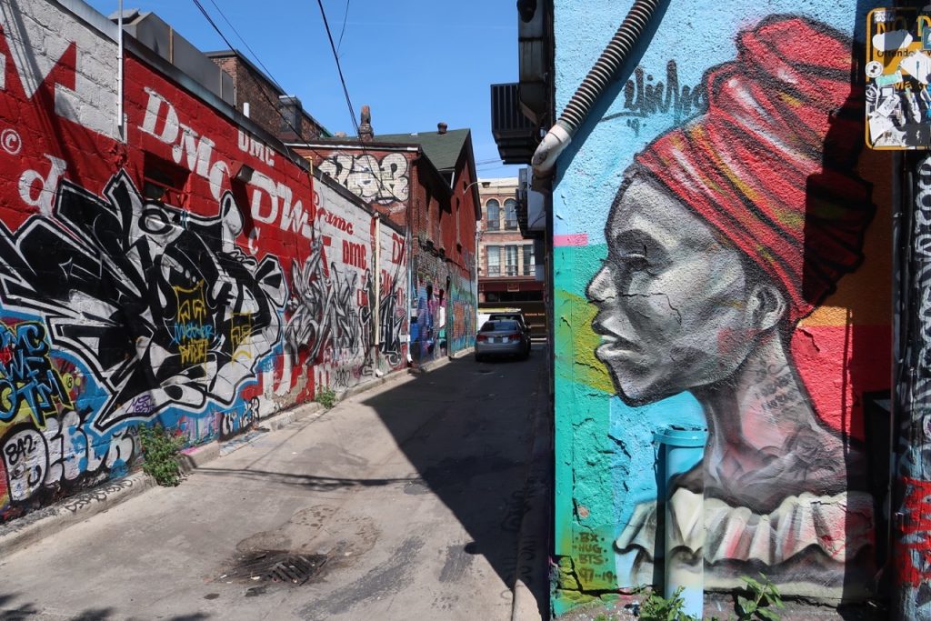 Graffiti Alley Toronto street art, profile of woman wearing head dress on wall