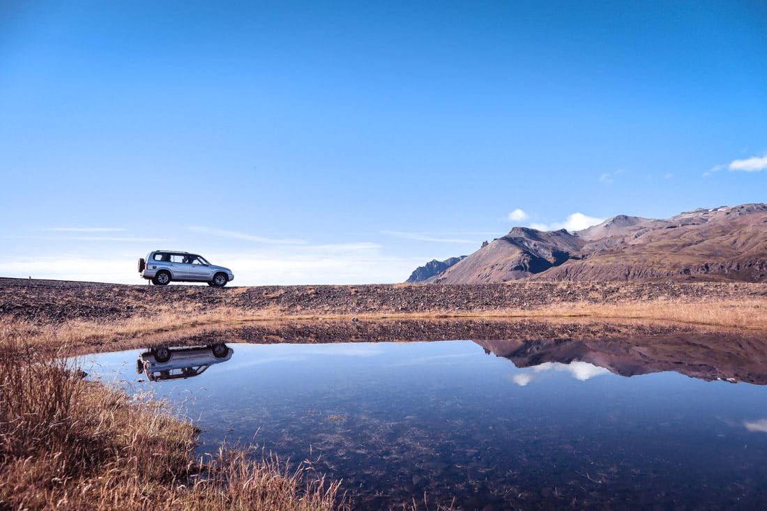 Car Iceland landscape, reflection in water
