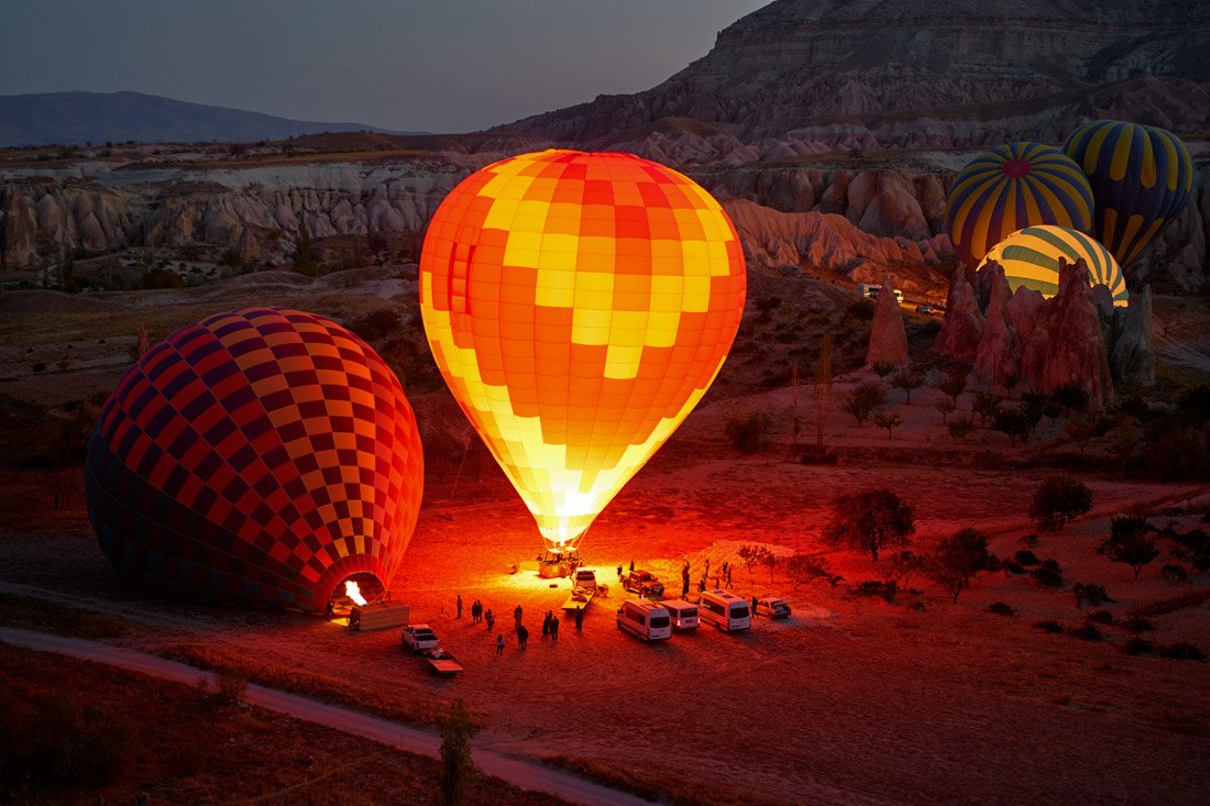 Hot air balloons lighting up Cappadocia Turkey sunrise