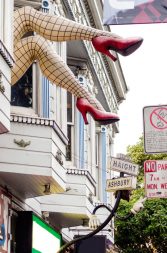 Legs with fishnets and red shoes sign in San Francisco Castro District
