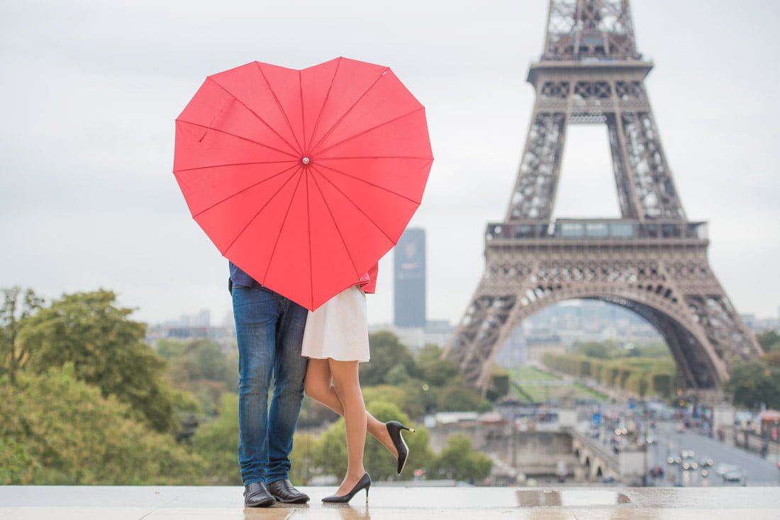 Red heart umbrella, couple kissing, romantic Eiffel Tower