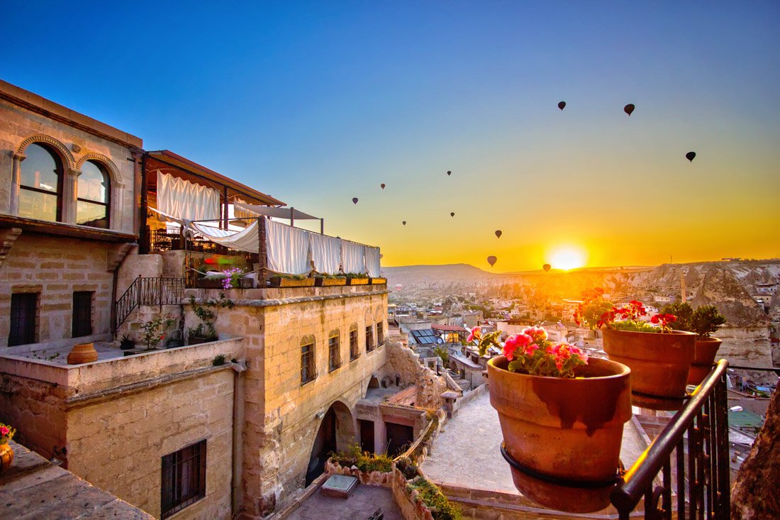 Terrace, hot air balloons, flowers, cave hotel, Cappadocia Turkey