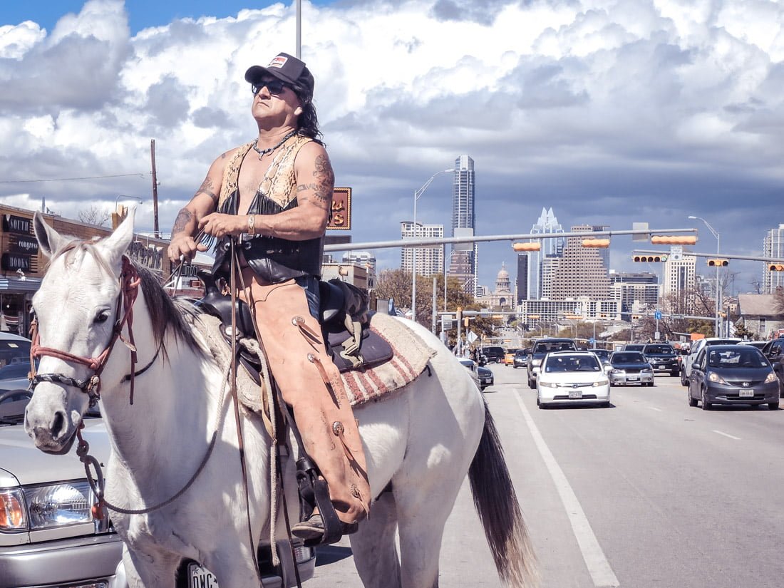 Man on horse South Congress buildings