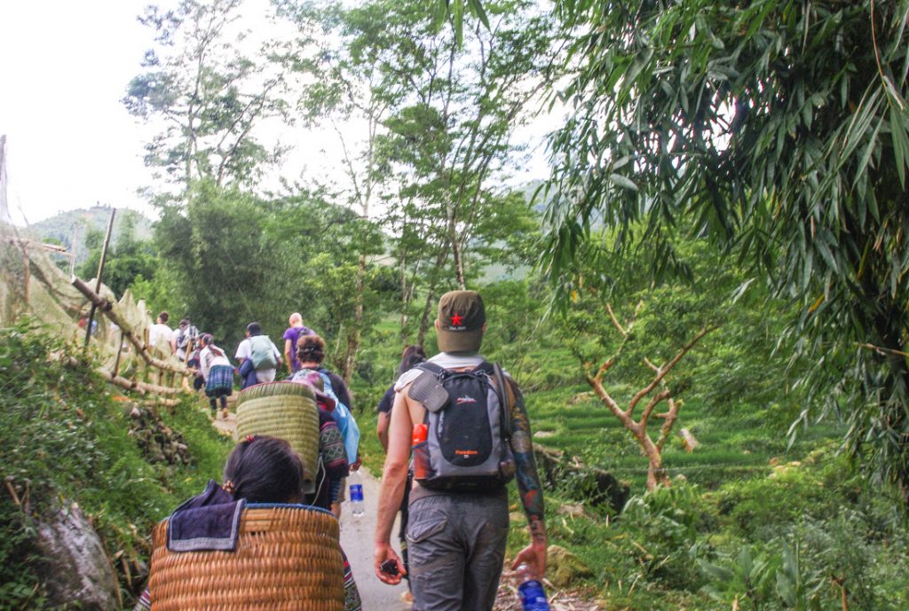 Hiking Sapa Valley in Vietnam, Craig, day bag, flip flops, bug spray, water bottle, native woman.