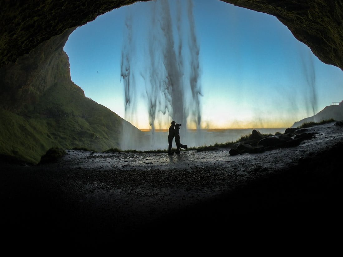 Couple at Seljalandsfoss Waterfall Iceland sunset