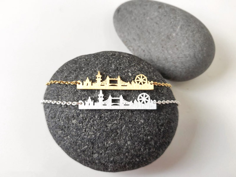 London skyline necklace gold and silver on grey rock