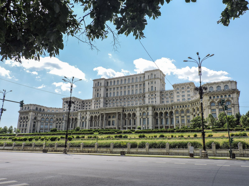 Palace of Parliament Bucharest framed by leaves with blue skies