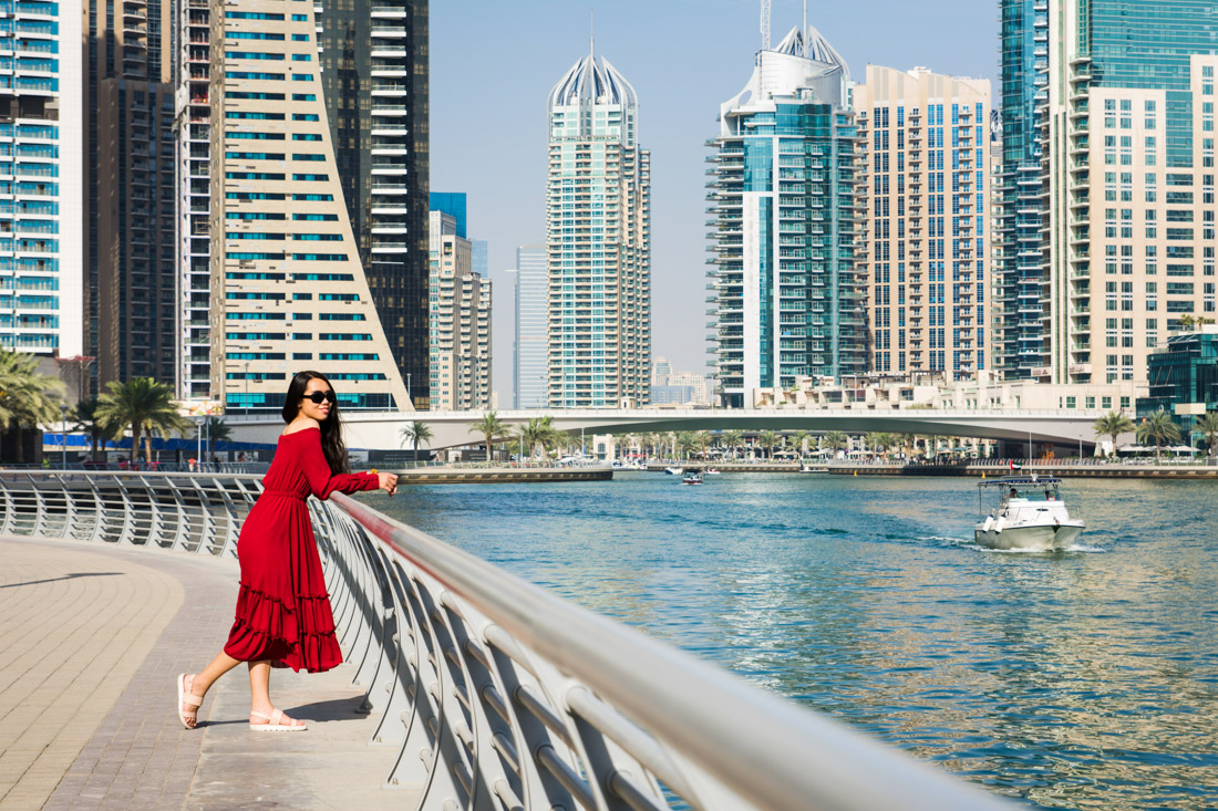 Girl in red dress with Dubai skyline