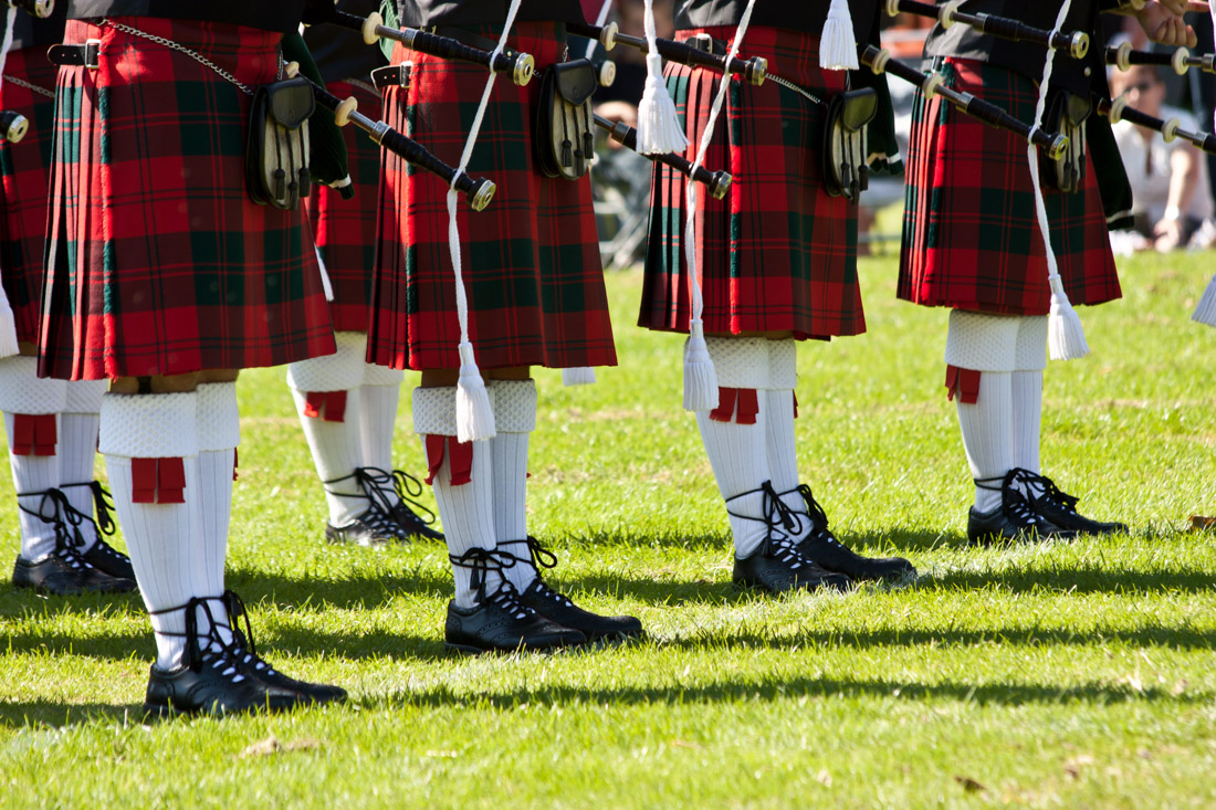 Pipers in a row wearing kilts