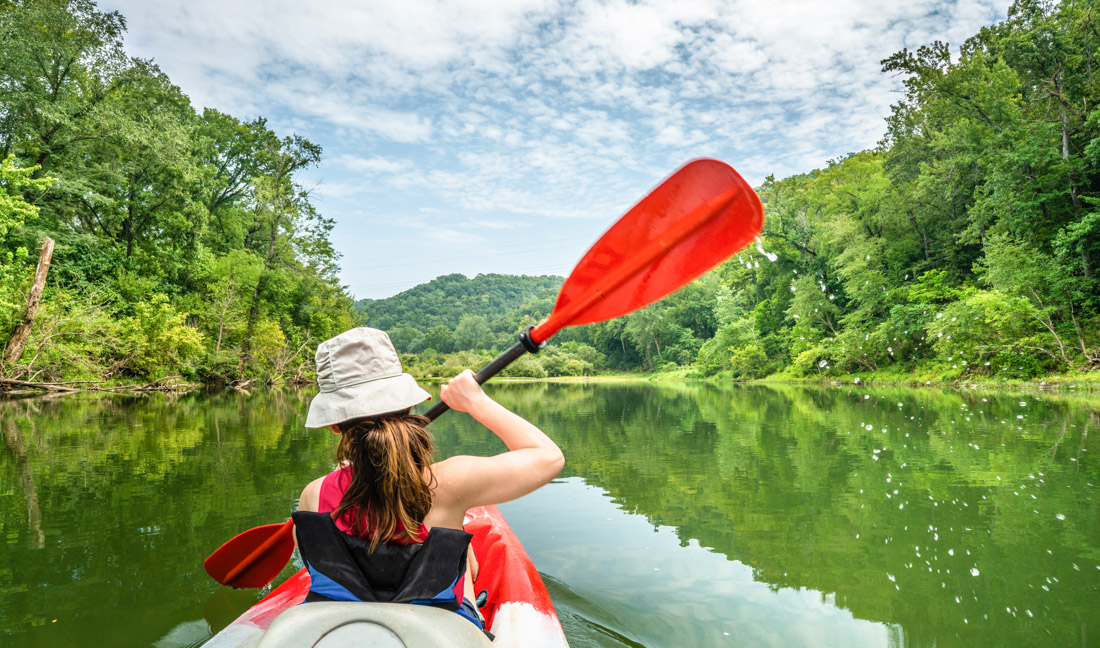 girl paddling along the Buffalo River in Arkansas