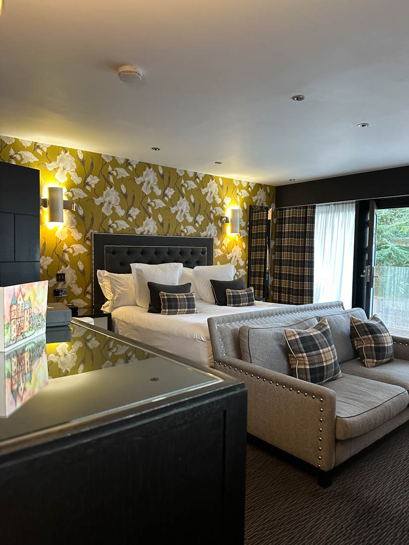 Contemporary suite with bed and sofa at Fonab Castle Pitchlochry