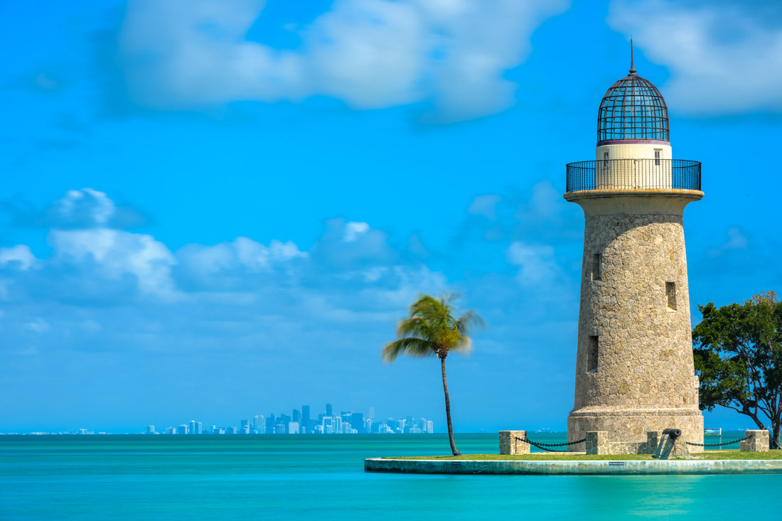 Striking blue ocean at Boca Chita Lighthouse and Miami Skyline on calm day
