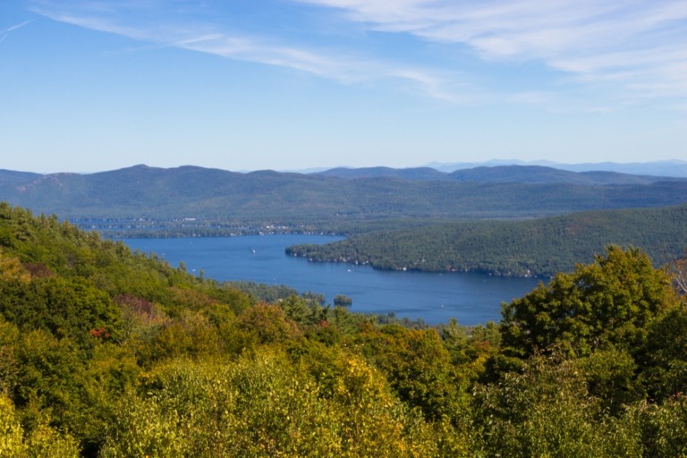 Lake George New York State trees with blue lake and sky