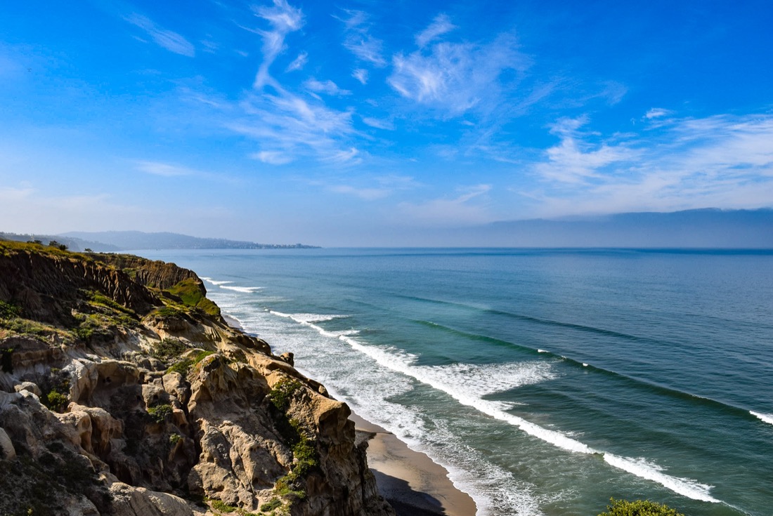 Ocean crashes onto cliff rocks in Carmel California 