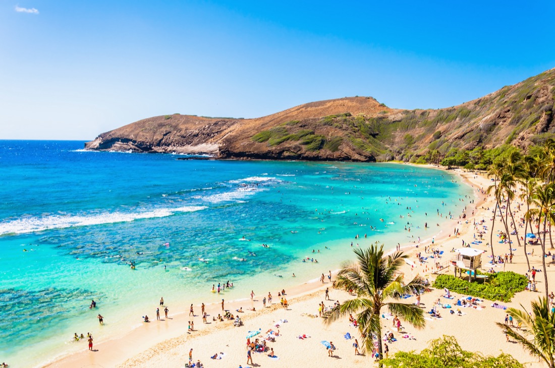 Blue ocean. sandy beach and cliffs of Hanauma Bay at Oahu in Hawaii.