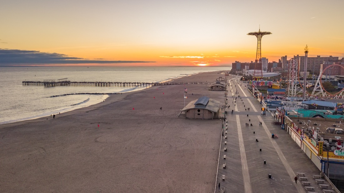 Aerial view on Coney Island and sands of Brighton Beach at sunset in NYC