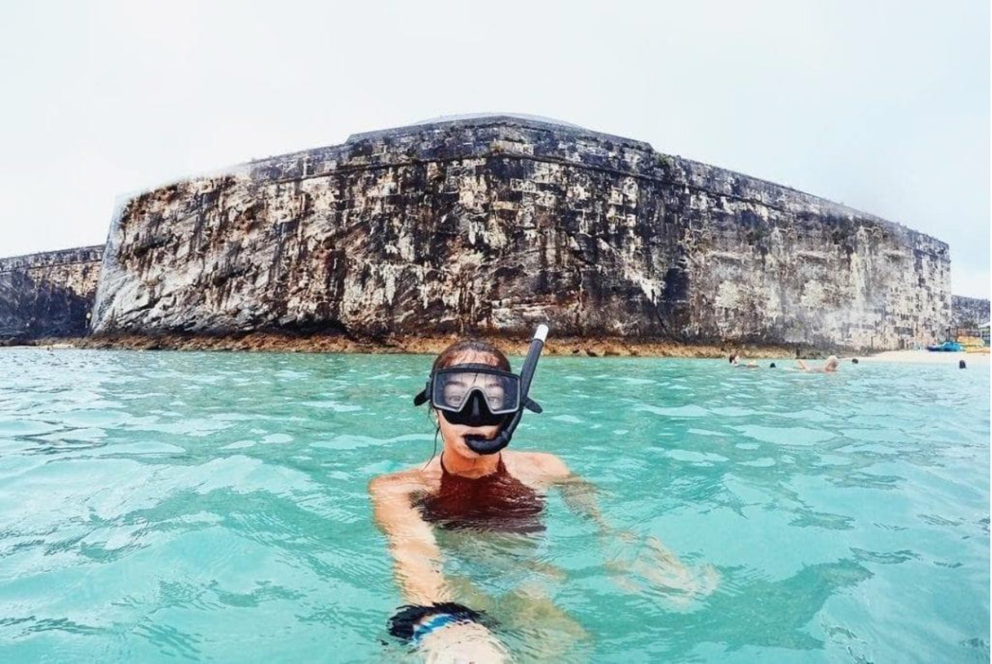 Woman snorkeling in clear waters in Bermuda