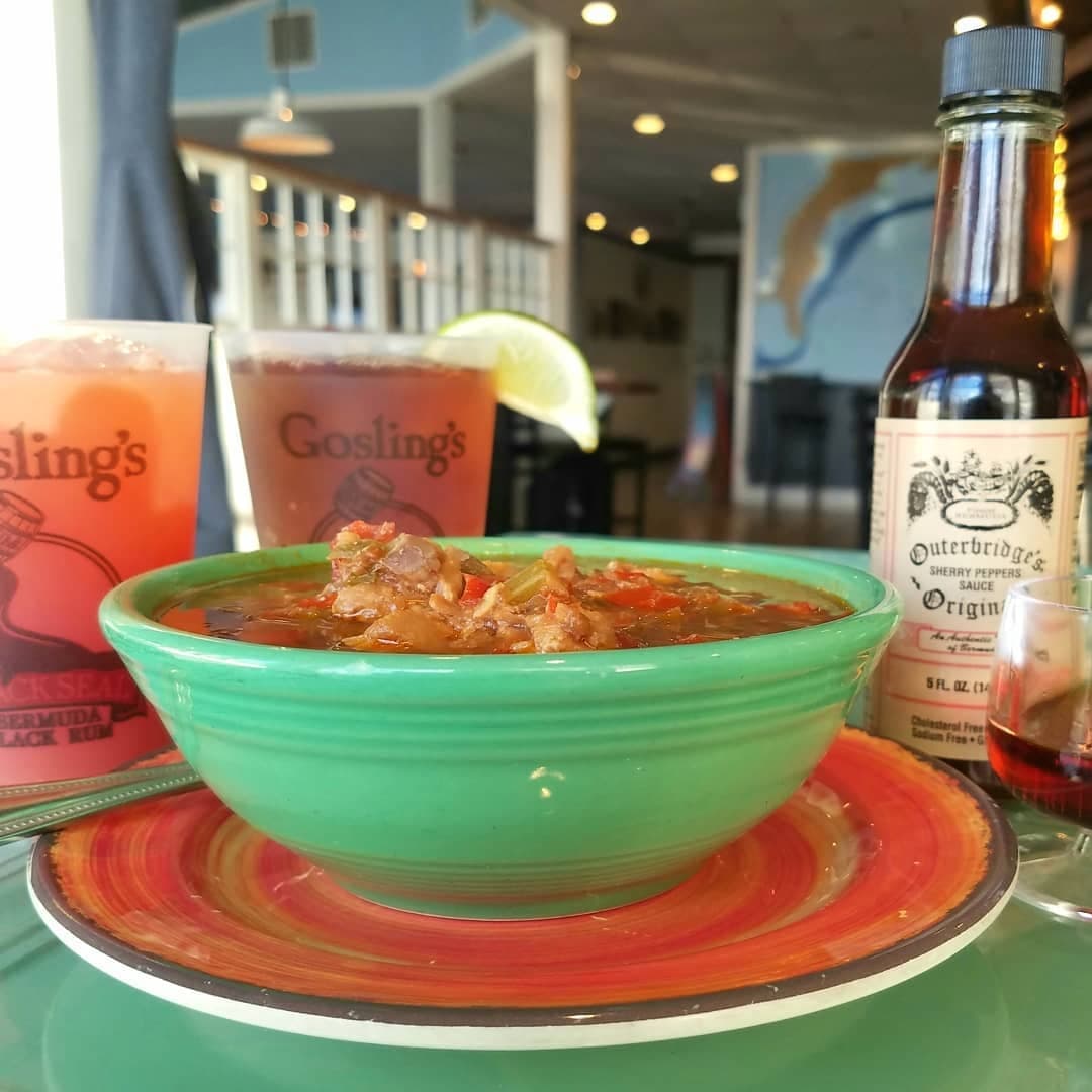 Green bowl of fish chowder in Bermuda