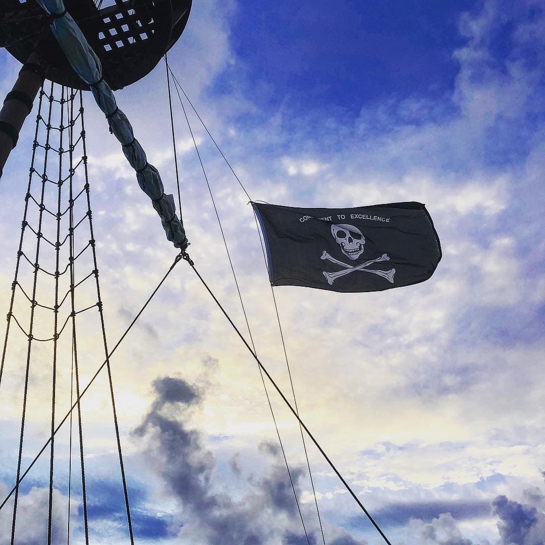 Purple sky and skeleton on flag at Pirate Bar Bermuda