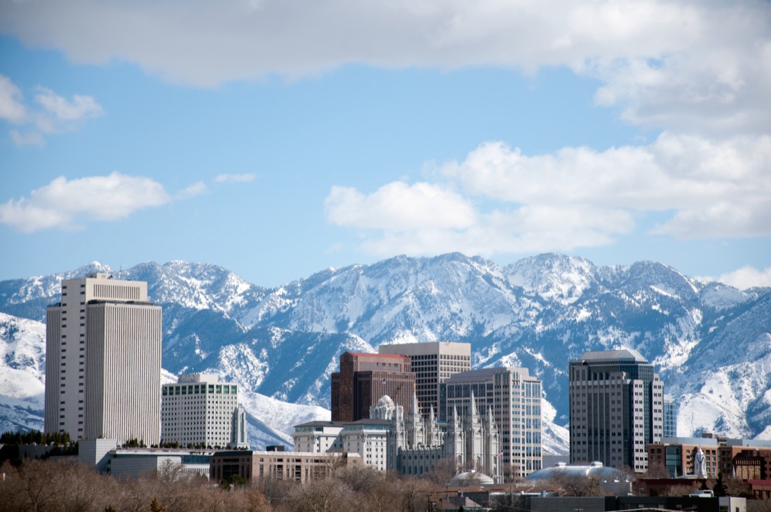 Salt Lake City skyline with snowy mountains.