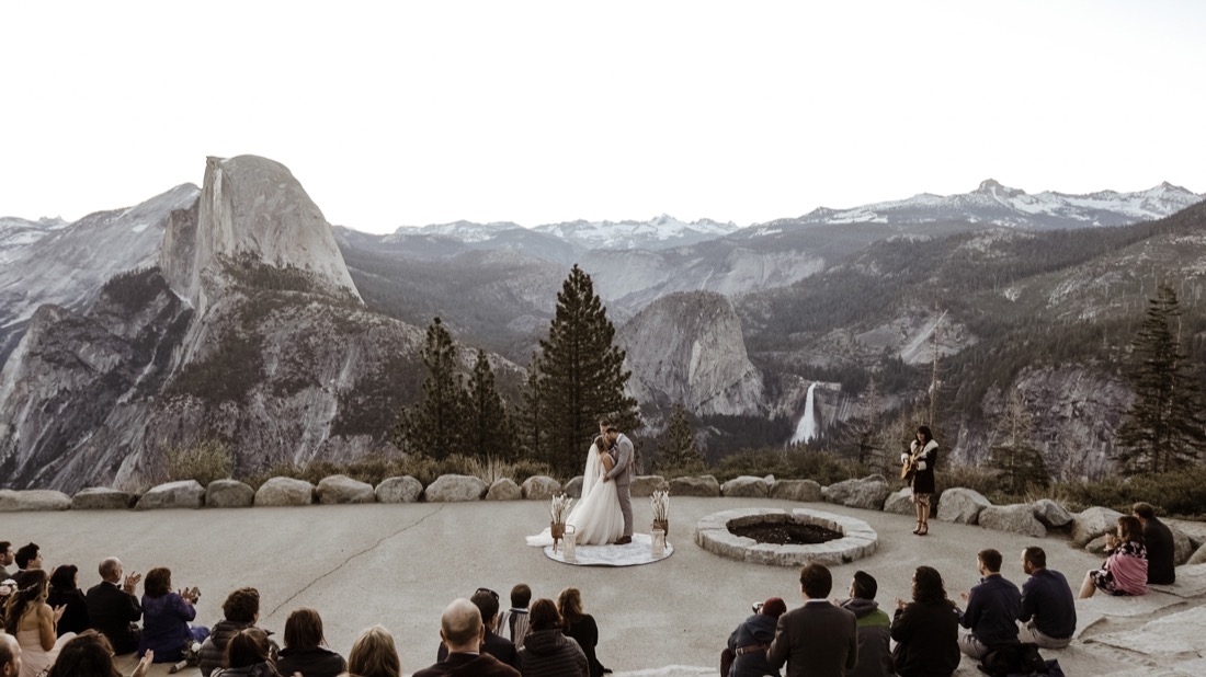 Wedding couple surrounded by guests at Yosemite National Park