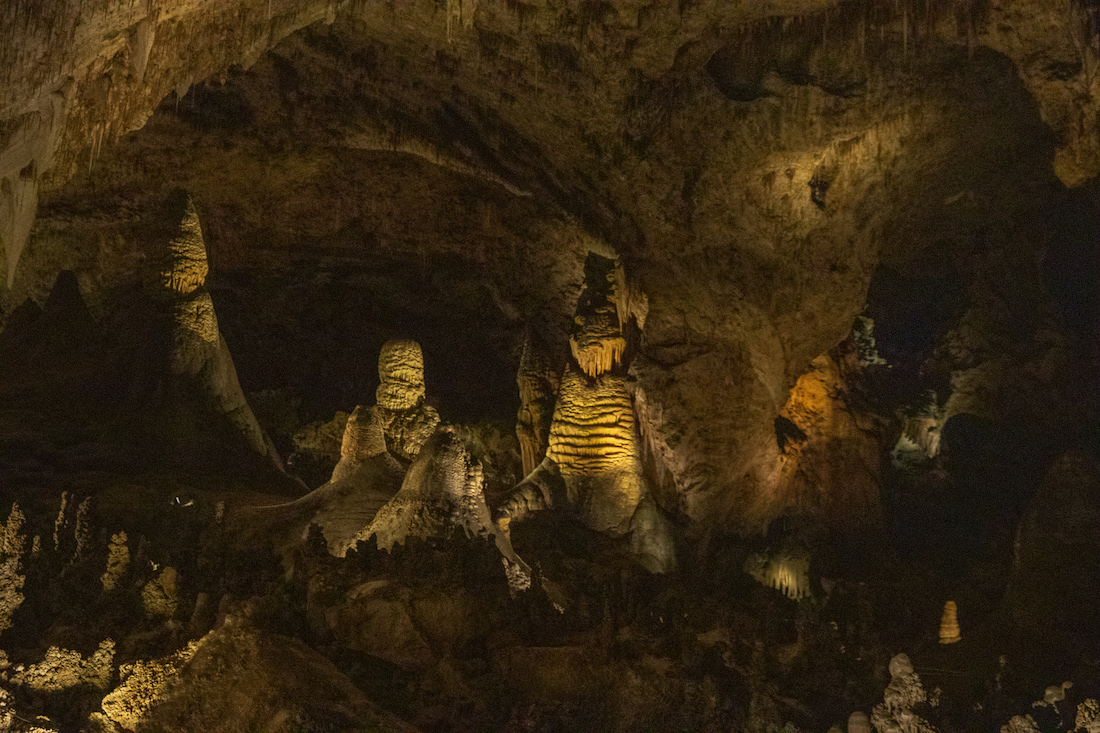 Dark cave yellow light Carlsbad Cave