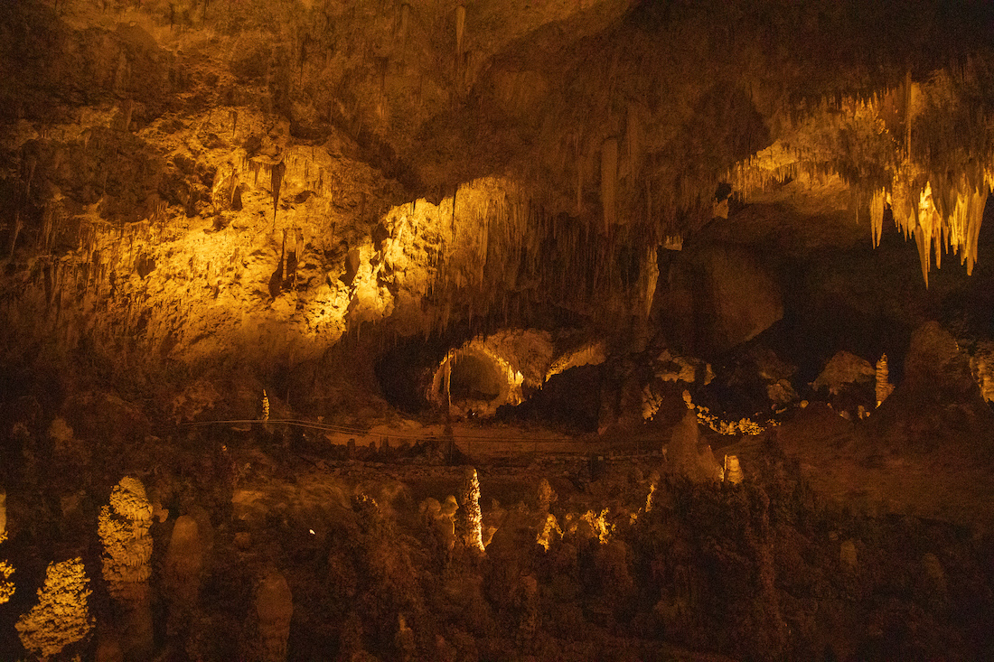 Dark cave with orange light at Carlsband Caverns